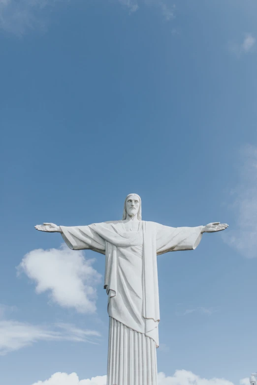 a statue that looks like jesus is reaching his arms out