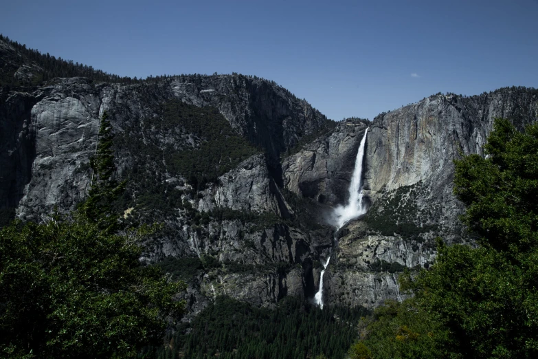 an up - close s of waterfall taken from below, in the mountains