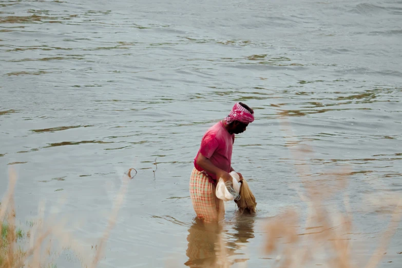 the woman in pink shirt is holding two baskets