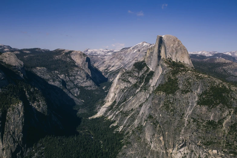 an aerial view of mountains with rocks and trees