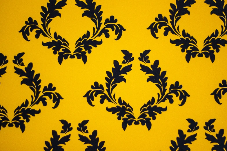 an ornate blue flower design is on a yellow background