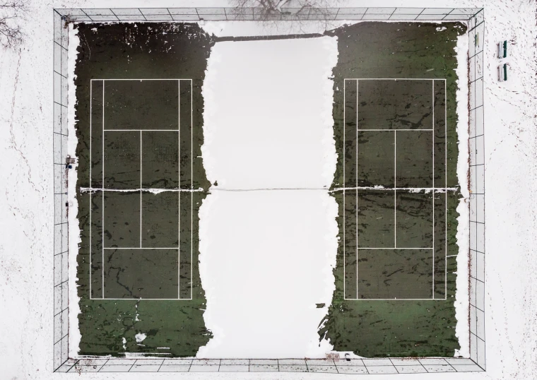 a tennis court is covered in snow, with the goal being painted