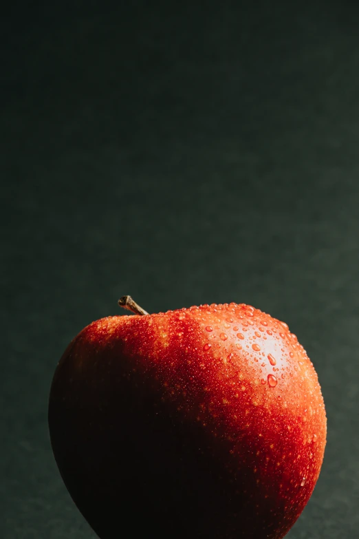 a large red apple sitting on top of a table