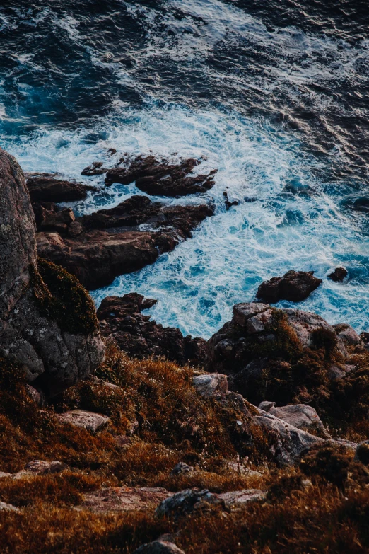 some rocks in the water on a cloudy day