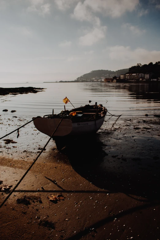 a small boat sitting on top of a beach