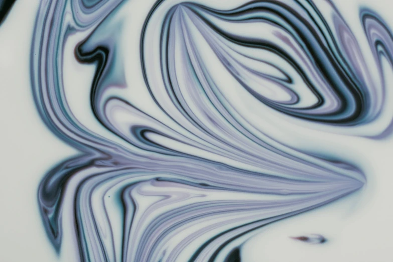 an artistic image of purple, white and black paint swirling down a wall