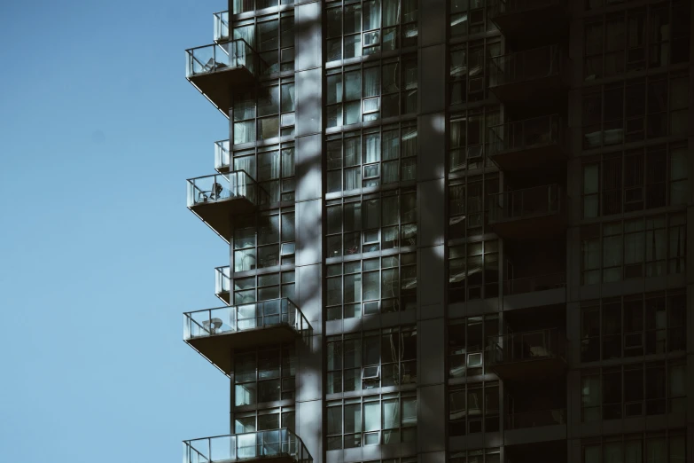 the glass windows on the side of the tall building