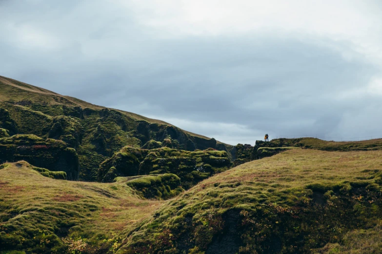 two people standing on the edge of a cliff