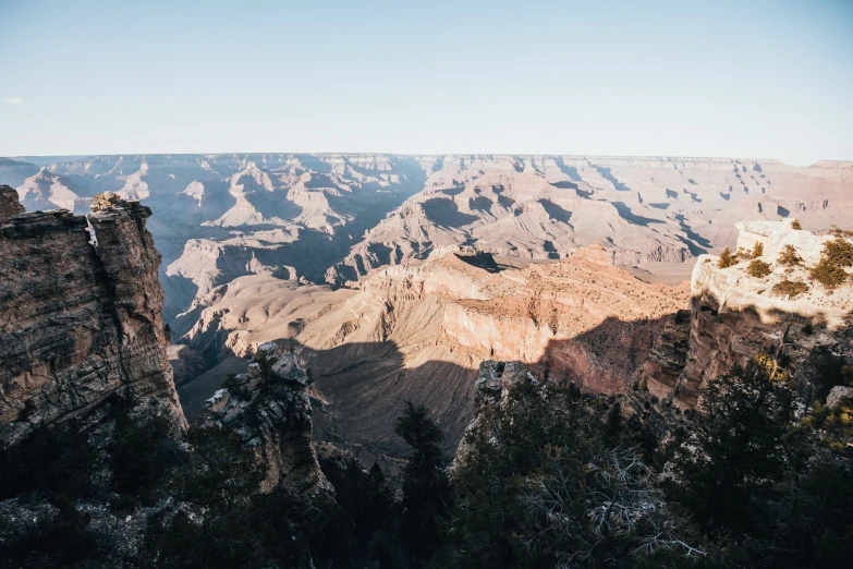 a mountain view with many tall cliffs and trees in it