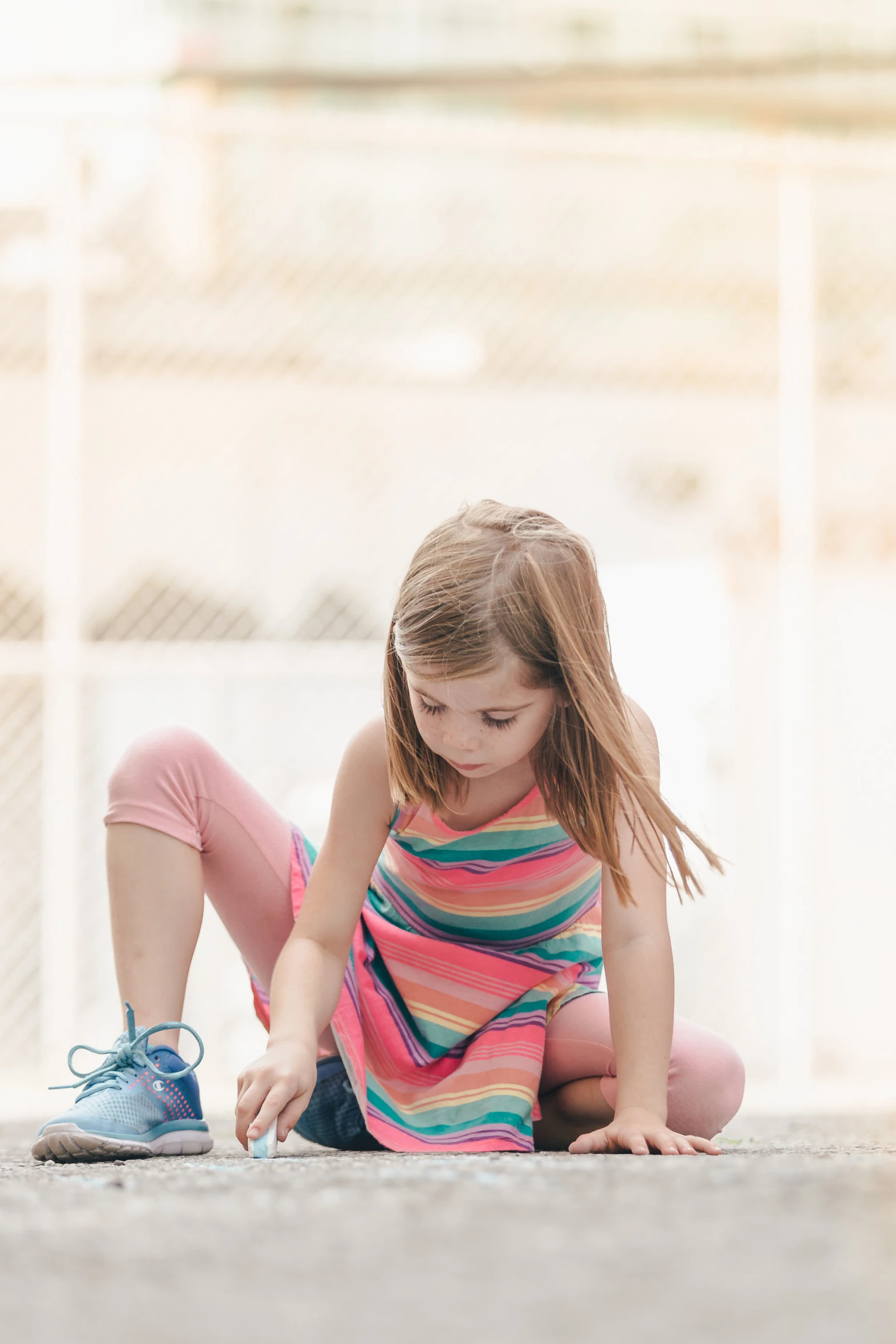 a little girl is kneeling on the ground