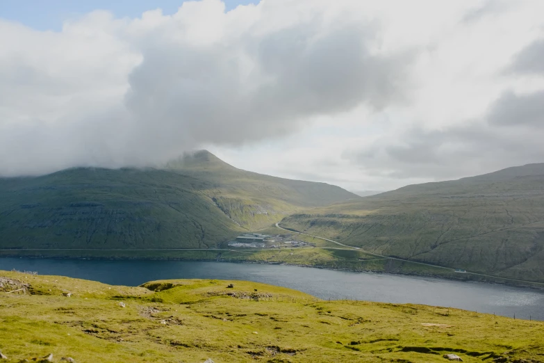 fog hovering over the top of the mountains