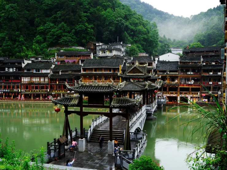 an area of asian style buildings overlooking a river
