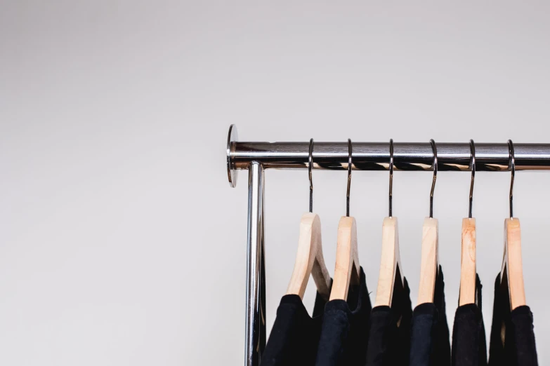 clothes hanging in line on rail with clothes hanging