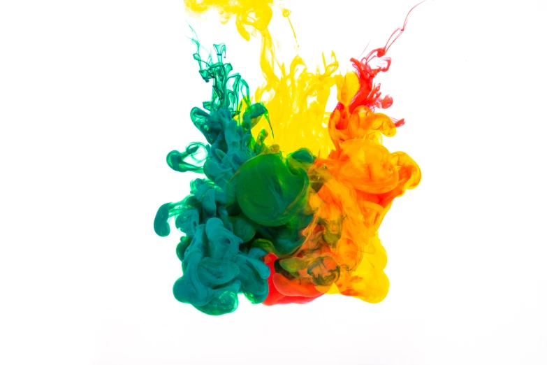 multi colored ink floating in water on a white surface