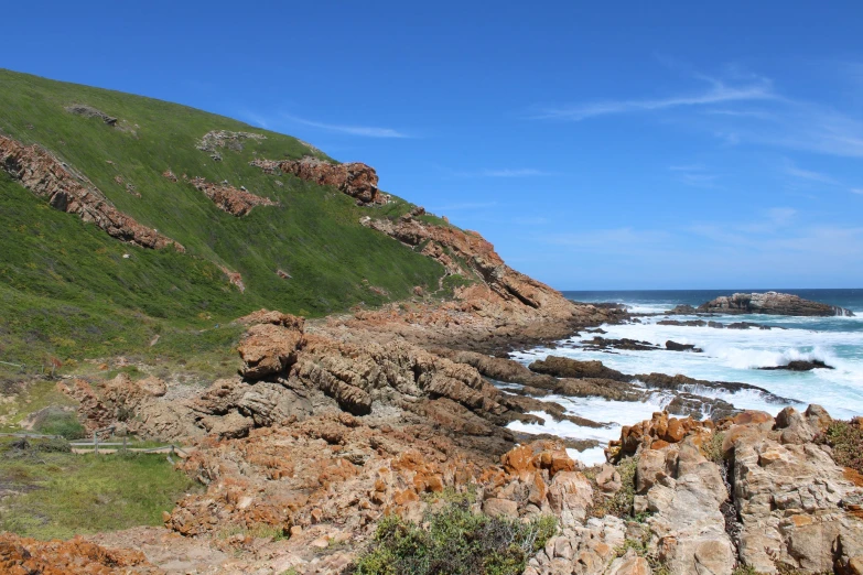 some very pretty waves in the ocean by some rocky shore