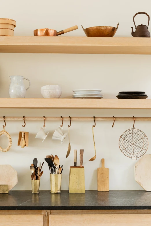 pots and pans are hanging on a rack