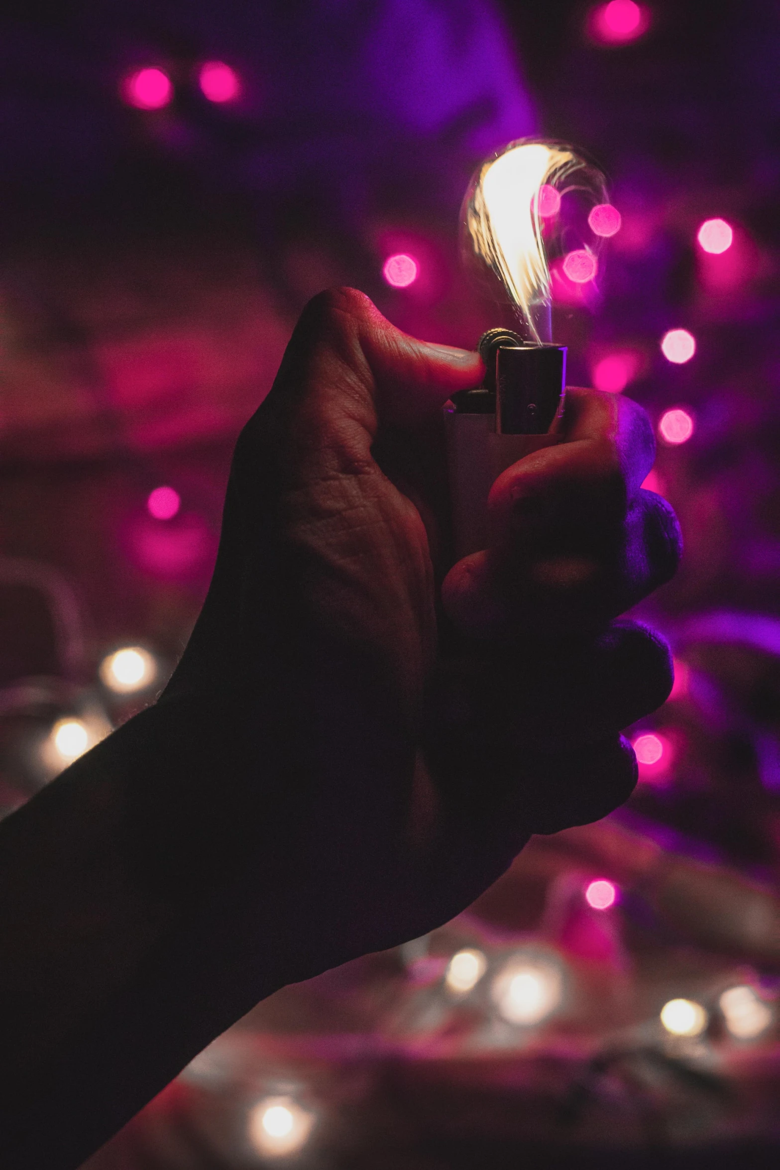 a person holding a lighter in their hand