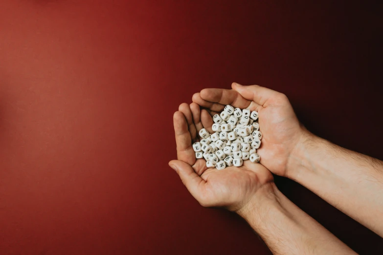 two hands holding a bunch of small objects