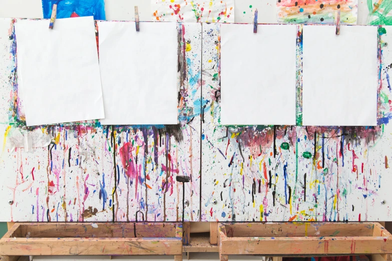 three large wooden crates with three different colored pieces of paper hanging on them