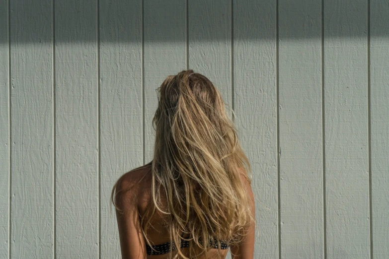 back view of a woman with long, blonde hair