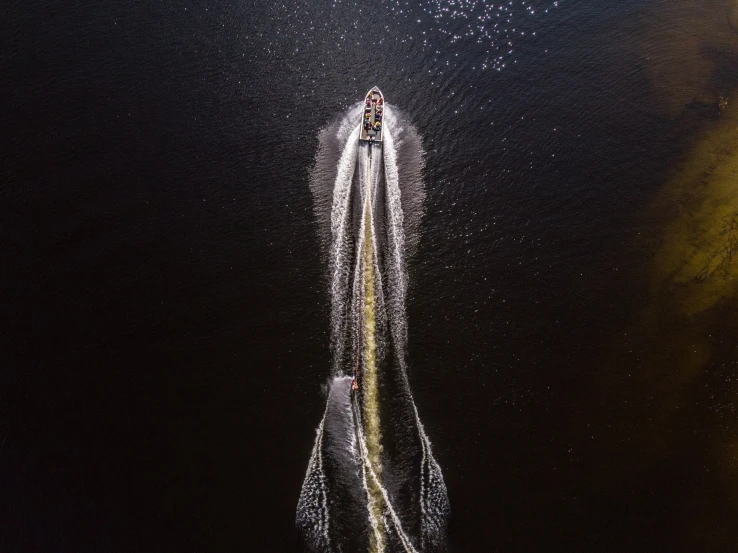 a small boat is going along a bridge