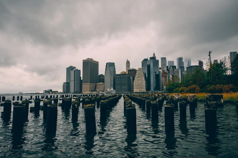 an empty pier overlooks the city skyline