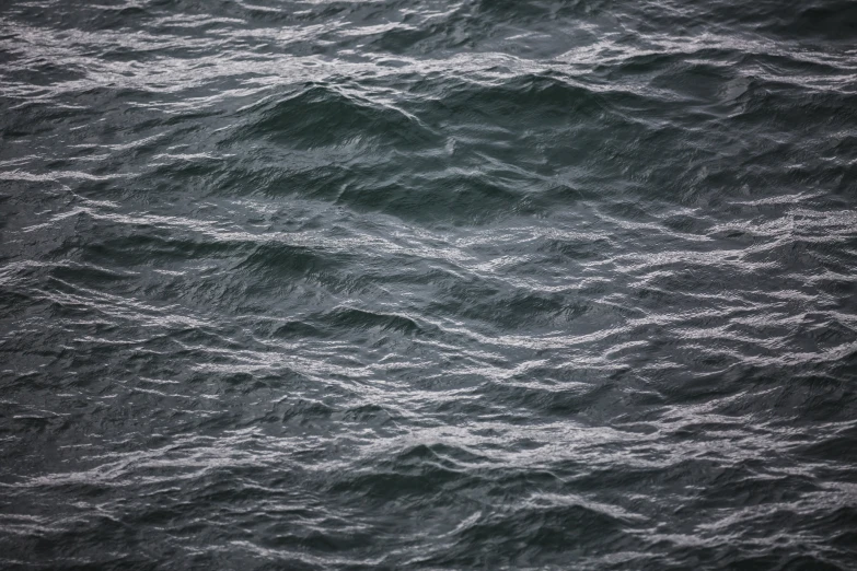 a very dark and wavy image in the ocean