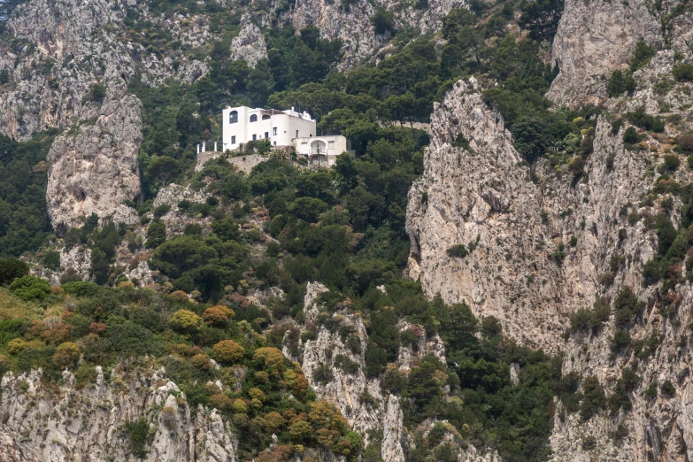 a house perched on the side of a mountain cliff