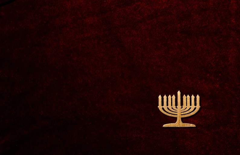 a golden hanuchkah on a red background