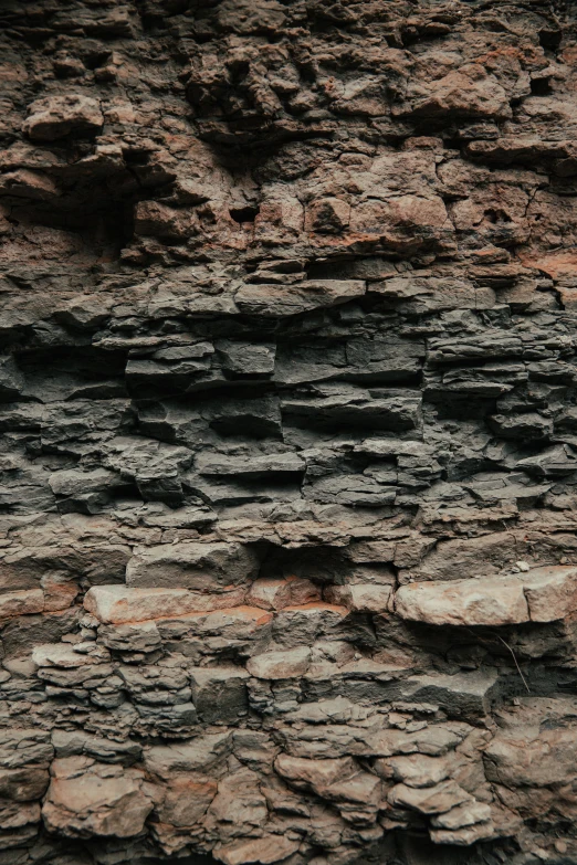 a bird flying past a rocky outcropping