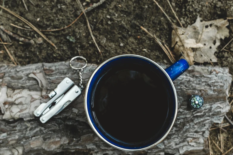 a mug of coffee next to two keys