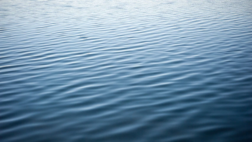 a blue body of water with no waves on it