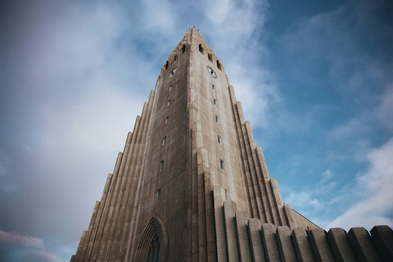 a very tall building surrounded by a blue sky