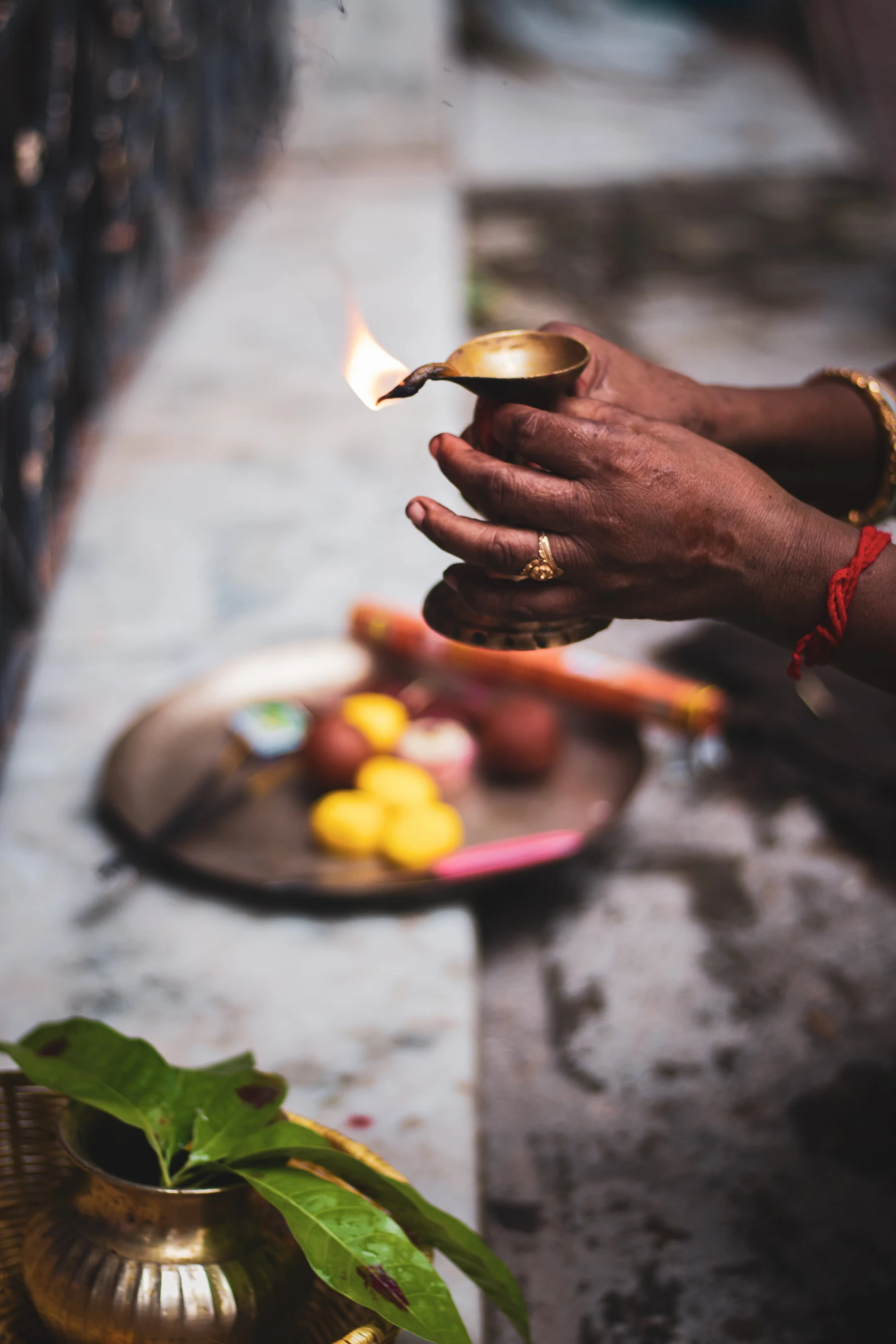 a person lighting a candle with their hands