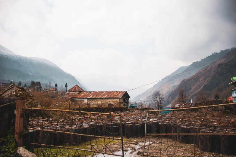 several small houses in the distance surrounded by a mountain