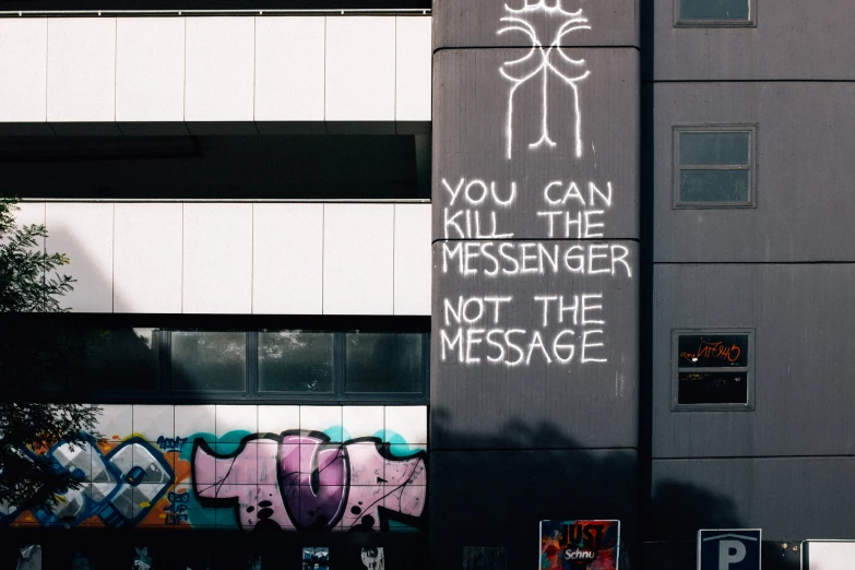 a building with graffiti written in white ink