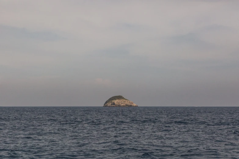 a small island on the ocean with water around it