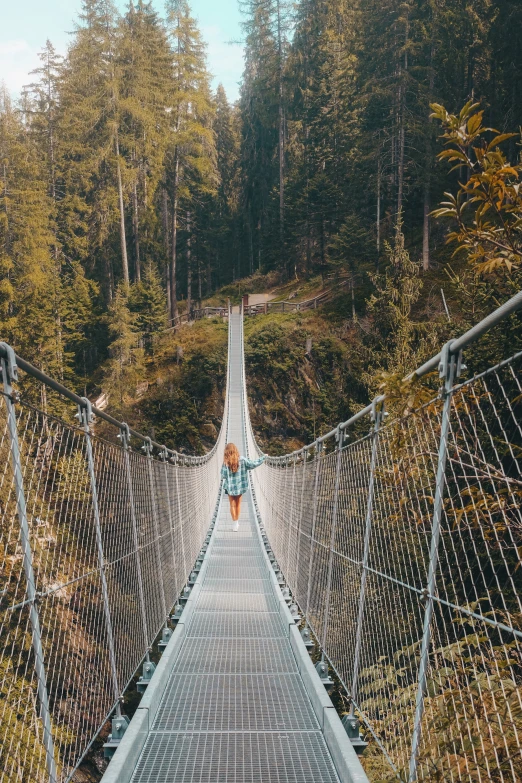 a person that is standing on a very high bridge