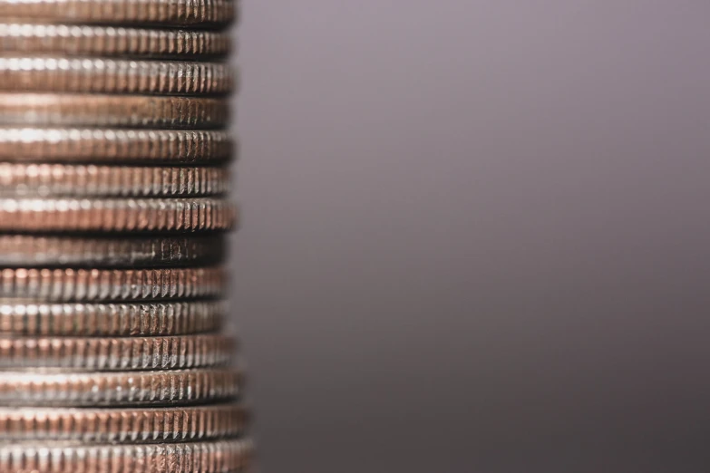 stacked stacks of coins with only one coin left on top