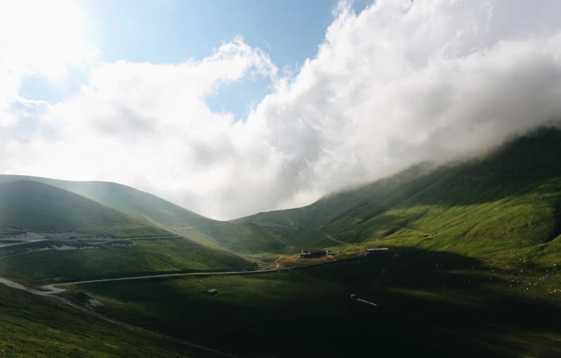 a valley with a road passing through the middle