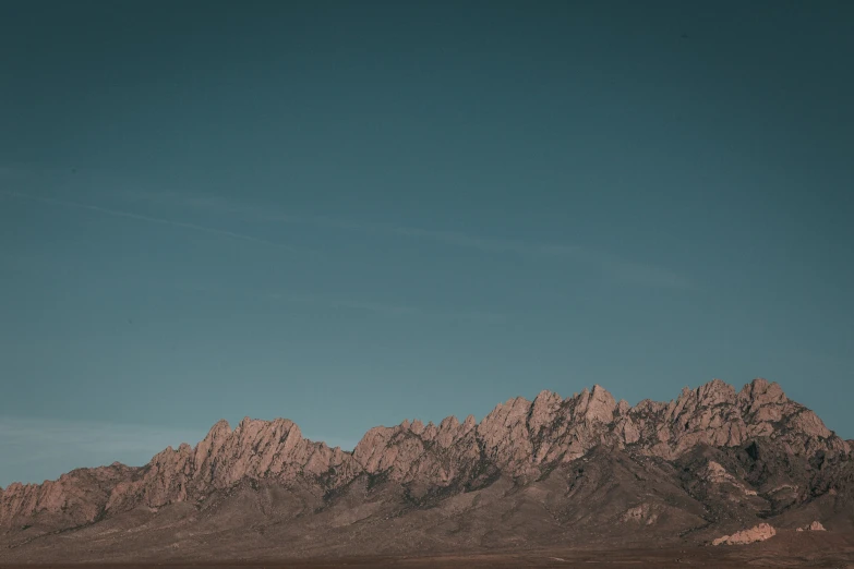 a plane is flying through the air over a hill