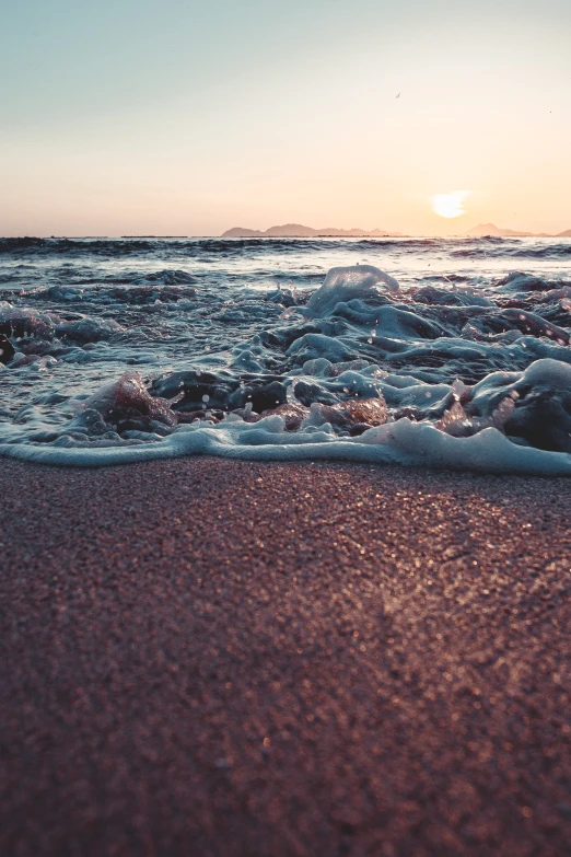 there are some waves on the sand by the beach