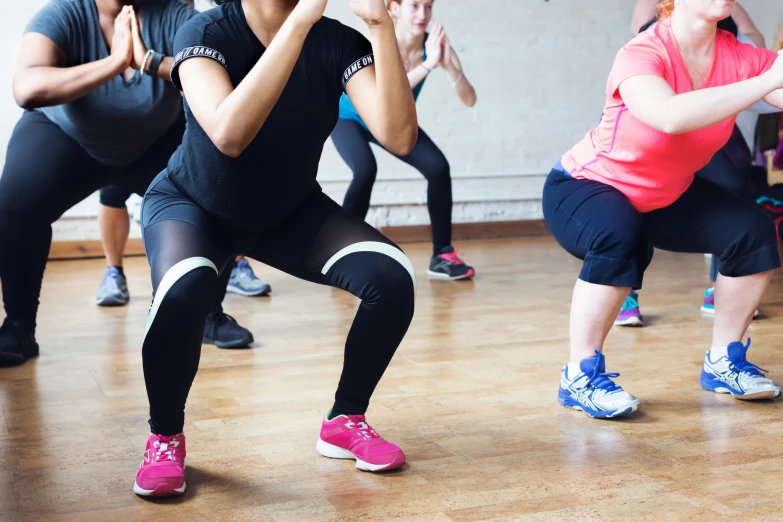 some girls doing a squat dance exercise