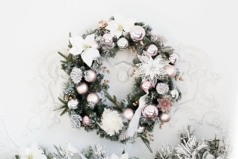 a white wreath with silver and silver ornaments