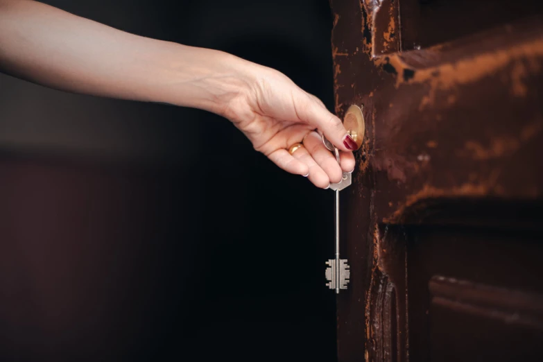 the hand is pressing on a handle that goes to a door