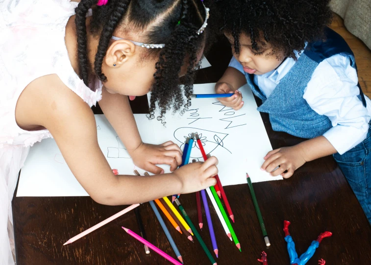 two s with crayons on the table