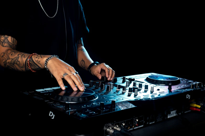 a dj playing a track on an audio mixer