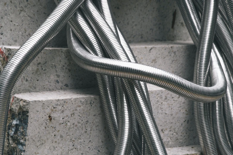 stainless steel cables are lined up on concrete stairs