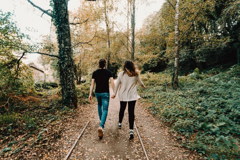 a couple walking together on a path through a park