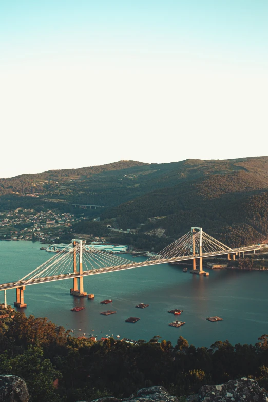 the suspension bridge is located at the top of a hill